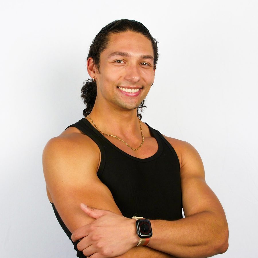 Jarred Carter smiling with his arms crossed, in a black tank top